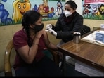 A health worker administers Covid-19 vaccine at a government school in New Delhi. (AP) A health worker administers Covid-19 vaccine at a government school in New Delhi. (AP)