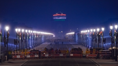 Security personnel stand guard near a barricade at Rajpath in New Delhi, on the eve of the Republic Day 2022 Parade. (PTI) Security personnel stand guard near a barricade at Rajpath in New Delhi, on the eve of the Republic Day 2022 Parade. (PTI)