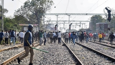 Aspirants block railway tracks during their protest over alleged erroneous results of Railway Recruitment Board's Non-Technical Popular Categories (RRB NTPC) exam 2021, in Prayagraj, Tuesday, Jan. 25, 2022. (PTI) Aspirants block railway tracks during their protest over alleged erroneous results of Railway Recruitment Board's Non-Technical Popular Categories (RRB NTPC) exam 2021, in Prayagraj, Tuesday, Jan. 25, 2022. (PTI)