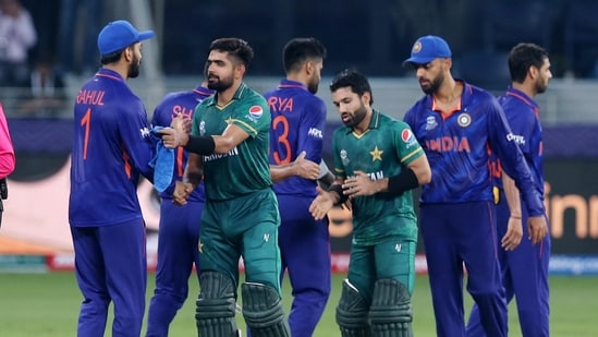 Pakistan's Mohammad Rizwan and Babar Azam shake hands with the India players after the match.(REUTERS)