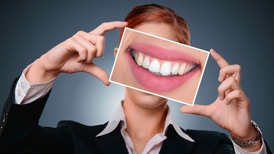 There is no dearth of DIY teeth whitening techniques available on internet that advise one to use things like activated charcoal, baking soda and apple cider vinegar to make teeth white and shiny. But some of them could have side-effects and may end up damaging teeth instead of being beneficial. An Ayurveda expert shares five natural remedies that can help you maintain your dental hygiene and make your teeth whiter.(Pixabay)