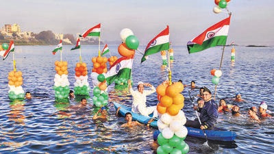 Surat: People hold the national flags as they swim in the Tapi river to celebrate Republic Day, in Surat, Wednesday, January 26, 2022. (PTI Photo) (PTI01_26_2022_000272B) (PTI) Surat: People hold the national flags as they swim in the Tapi river to celebrate Republic Day, in Surat, Wednesday, January 26, 2022. (PTI Photo) (PTI01_26_2022_000272B) (PTI)
