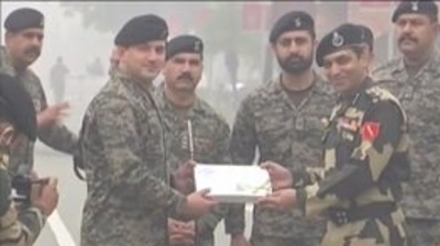 Republic Day 2022 celebrations: BSF, Pakistan Army exchange sweets, greetings at Attari-Wagah border. (ANI) Republic Day 2022 celebrations: BSF, Pakistan Army exchange sweets, greetings at Attari-Wagah border. (ANI)