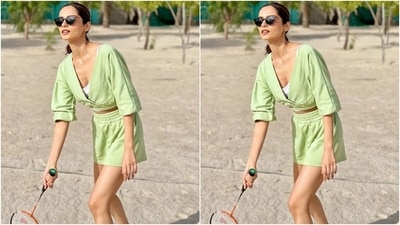 Manushi teamed the blouse with matching sage green shorts carrying an elasticated waistband and ribbed hem. She styled the look with cat-eye sunglasses, a sleek chain, chunky multi-coloured sneakers, centre-parted ponytail, nude brown lip shade and glowing skin. (Instagram/@manushi_chhillar)