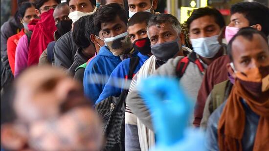 A BMC health worker collects swab samples for Covid-19 test of passengers arriving on outstation trains at Chhatrapati Shivaji Maharaj Terminus in Mumbai on Tuesday (HT Photo/Bhushan Koyande)