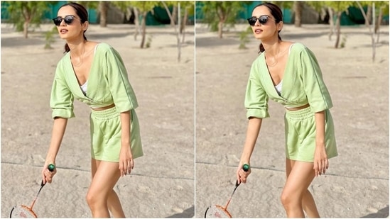 Manushi teamed the blouse with matching sage green shorts carrying an elasticated waistband and ribbed hem. She styled the look with cat-eye sunglasses, a sleek chain, chunky multi-coloured sneakers, centre-parted ponytail, nude brown lip shade and glowing skin.(Instagram/@manushi_chhillar)