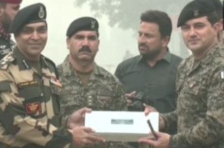 The Border Security Force (BSF) and the Pakistani Army exchange sweets and greetings at the Attari-Wagah border.&nbsp;(ANI)