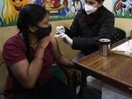 A health worker administers Covid-19 vaccine at a government school in New Delhi. (AP)