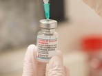 A health care worker fills up a syringe with a dose of Moderna's Covid-19 vaccine for a booster shot at the vaccination reference center at the Epidemiology, Biostatistics and Prevention Institute (EBPI) in Zurich, Switzerland.