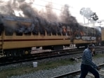 Smoke comes out from a train's carriage after angry mobs set it on fire in protests over RRB results, in Bihar's Gaya on Wednesday.(AFP Photo) Smoke comes out from a train's carriage after angry mobs set it on fire in protests over RRB results, in Bihar's Gaya on Wednesday.(AFP Photo)