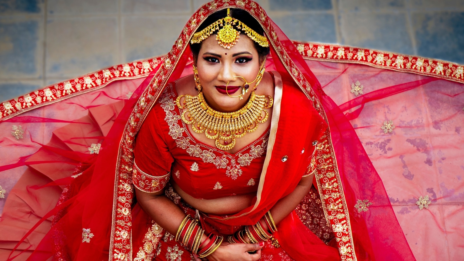 Design an original red wedding lehenga for 5 ft 1 inch bengali girl whose  figure is midsize. make the design very bengali traditional on Craiyon