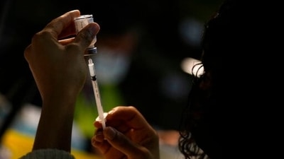 A Pharmacist filling a syringe with Covid-19 vaccine. (AP | Moderna)