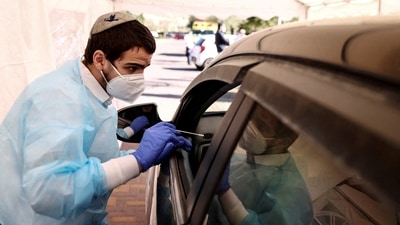 Medical staff carry out tests for Covid-19 at a drive-through site in Jerusalem, Israel. (Reuters File Photo)