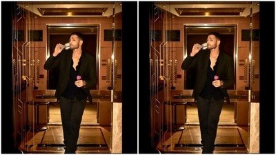 Siddhant added more date night vibes to his look with a champagne glass and a pink rose in his hand. (Instagram/@siddhantchaturvedi)