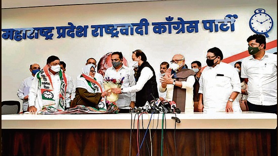 Maharashtra Deputy Chief Minister Ajit Pawar congratulates Malegaon Mayor Tahira Shaikh with a bouquet for joining Nationalist Congress Party (NCP), in Malegaon on Thursday. (ANI)