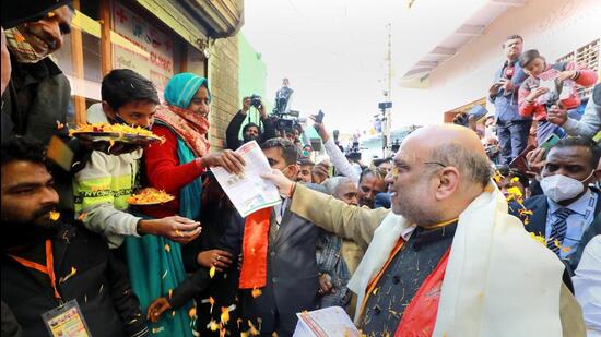 Mathura: Union Home Minister Amit Shah during door to door election campaign at Satoha village in Mathura district, Thursday, Jan. 27, 2022. (PTI Photo)(PTI01_27_2022_000098B) (PTI) Mathura: Union Home Minister Amit Shah during door to door election campaign at Satoha village in Mathura district, Thursday, Jan. 27, 2022. (PTI Photo)(PTI01_27_2022_000098B) (PTI)