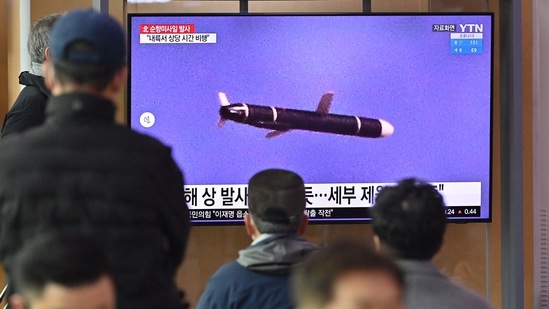 People watch a television screen showing a news broadcast with file footage of a North Korean missile test.(AFP) People watch a television screen showing a news broadcast with file footage of a North Korean missile test.(AFP)