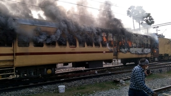 Smoke comes out from a train's carriage after angry mobs set it on fire in protests over RRB results, in Bihar's Gaya on Wednesday.(AFP Photo)