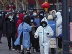 Residents wearing masks to help protect from the coronavirus gather in line as they wait for a throat swab at a Covid-19 test site outside a residential housing block in Fengtai district in Beijing, China on Wednesday.(Representative image/AP) Residents wearing masks to help protect from the coronavirus gather in line as they wait for a throat swab at a Covid-19 test site outside a residential housing block in Fengtai district in Beijing, China on Wednesday.(Representative image/AP)