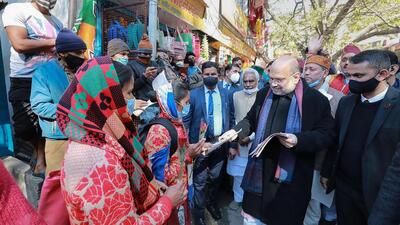 Union minister Amit Shah distributes pamphlets during his door-to-door campaign ahead of the Uttarakhand assembly elections, in Rudraprayag on Friday. (PTI) Union minister Amit Shah distributes pamphlets during his door-to-door campaign ahead of the Uttarakhand assembly elections, in Rudraprayag on Friday. (PTI)