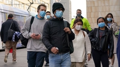 Commuters wear protective face masks as they enter Central Station following the implementation of new public health regulations in Sydney, Australia, June 23, 2021. (REUTERS)
