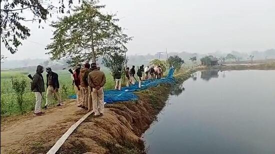 Police at a site where at least six people died after allegedly consuming spurious liquor in Buxar. (ANI)