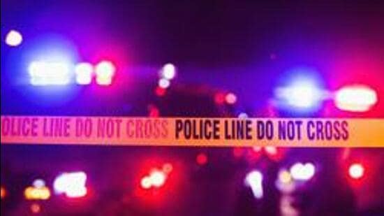 Accident or crime scene cordon tape, police line do not cross. It is nighttime, emergency lights of police cars flashing blue, red and white in the background (Getty Images/iStockphoto)