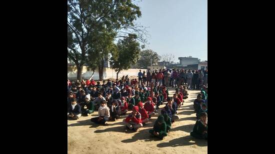 Children sitting on the ground at Government High School, Jhaloor, near Lehragaga of Sangrur district.