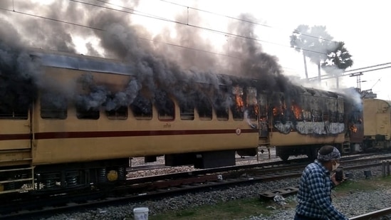 Smoke comes out from a train's carriage after angry mobs set it on fire in protests over RRB results, in Bihar's Gaya on Wednesday.(AFP Photo)