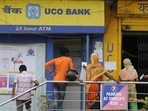 People stand in a queue outside the UCO Bank branch. People stand in a queue outside the UCO Bank branch.