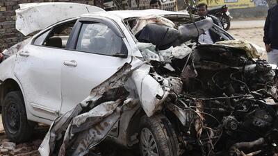 Gurugram, India - Dec. 3, 2021: On lookers gather around the mangled remains of a car post an accident where five people were killed, at Gari Harsu village, in Gurugram, India, on Friday, December 3, 2021. (Photo by Vipin Kumar/ Hindustan Times) (Vipin Kumar/HT PHOTO)