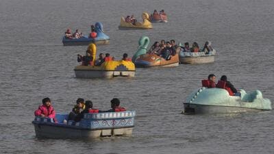 Residents enjoying boat ride at Sukhna Lake in Chandigarh on Sunday. (Keshav Singh/HT)
