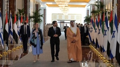 Israeli President Isaac Herzog and Foreign Minister of the UAE, Sheikh Abdullah bin Zayed Al Nahyan, talk as they walk through an airport in Abu Dhabi. (via Reuters)
