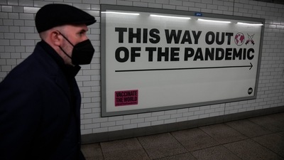 “This year we could end the acute phase of the #COVID19 pandemic if we vaccinate 70% of the population of every country,” WHO chief Tedros Adhanom Ghebreyesus said. In picture - A health campaign poster in an underpass leading to Westminster underground train station in London. (AP | Representational Image) “This year we could end the acute phase of the #COVID19 pandemic if we vaccinate 70% of the population of every country,” WHO chief Tedros Adhanom Ghebreyesus said. In picture - A health campaign poster in an underpass leading to Westminster underground train station in London. (AP | Representational Image)