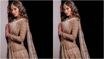Mouni's lehenga set features a cropped backless blouse with a plunging sweetheart neckline, corseted bodice, intricate gold jali, sequins and beaded embroidery, and sheer nude panels on the sleeves. (Instagram/@imouniroy) Mouni's lehenga set features a cropped backless blouse with a plunging sweetheart neckline, corseted bodice, intricate gold jali, sequins and beaded embroidery, and sheer nude panels on the sleeves. (Instagram/@imouniroy)