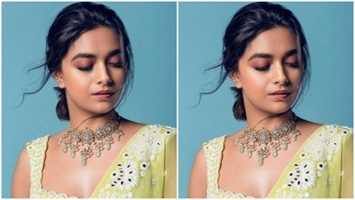 Keerthy paired a sleeveless green blouse embroidered in white cotton threads with a lime green flowy skirt. She teamed it with a silk green dupatta intricately embroidered in white cotton threads and zari. (Instagram/@keerthysureshofficial)