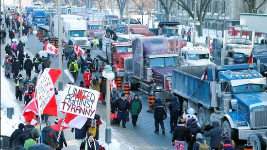 Trucks sit parked on Wellington Street near the Parliament Buildings as truckers and their supporters take part in a convoy to protest coronavirus disease vaccine mandates for cross-border truck drivers in Ottawa, Ontario, Canada. (REUTERS)