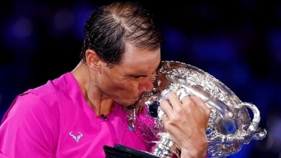 Rafael Nadal kisses the Australian Open trophy after defeating Daniil Medvedev in the men's singles final.(AP)