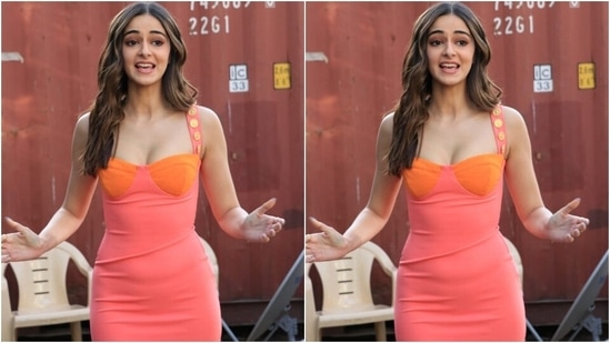 Ananya's orange and pink dress features a trendy mini hem length, a deep sweetheart neckline, a fitted silhouette hugging her svelte frame and broad straps with gold embellished buttons.(HT Photo/Varinder Chawla)