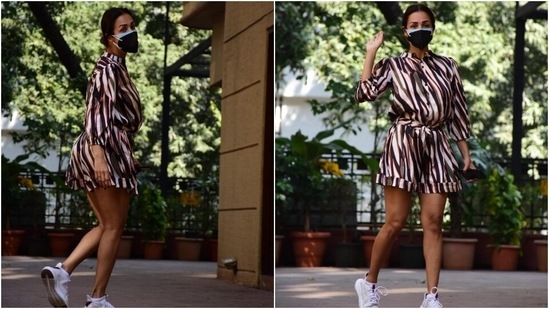 Malaika's day out outfit features blue, red and olive green stripes done all over. The romper also had a raised collar, button-up detail on the torso, a fabric belt tie to cinch the dress on the waist, gathered sleeves, folded hem, and a breezy silhouette.(HT Photo/Varinder Chawla)