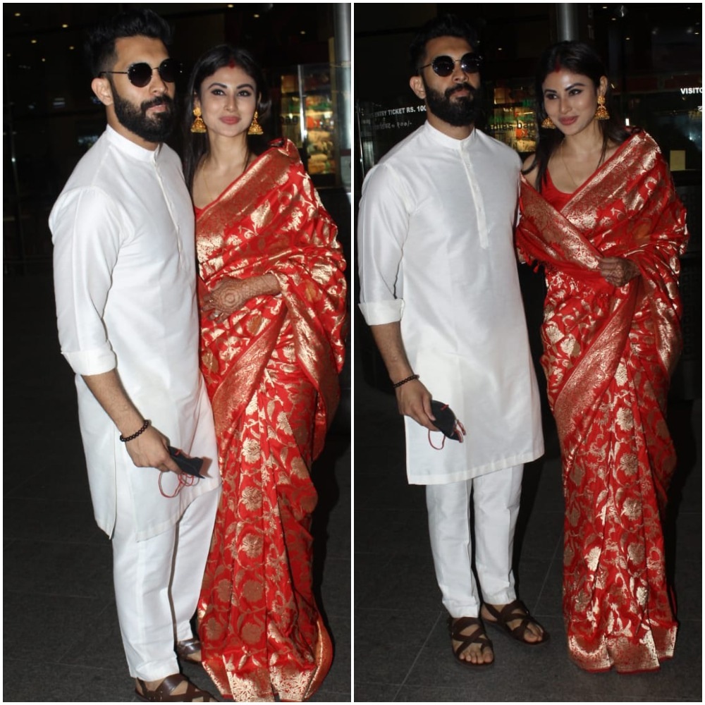 Mouni Roy and Suraj Nambiar pose at the airport.