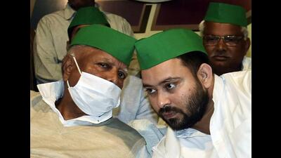 RJD chief Lalu Prasad Yadav with son Tejashwi Prasad Yadav. (ANI) RJD chief Lalu Prasad Yadav with son Tejashwi Prasad Yadav. (ANI)