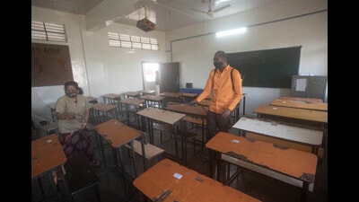 College staff is seen sanitising a classroom ahead of the reopening of colleges at Katraj on Monday. (Pratham Gokhale/HT Photo)