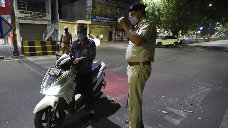 File photo of police stopping a man on two-wheeler during a night curfew. File photo of police stopping a man on two-wheeler during a night curfew. 