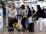 Passengers look at the flight schedule screen at Suvarnabhumi Airport in Bangkok on February 1, 2022, as Thailand resumes its quarantine free-travel scheme for vaccinated travellers (Photo by Jack TAYLOR / AFP) Passengers look at the flight schedule screen at Suvarnabhumi Airport in Bangkok on February 1, 2022, as Thailand resumes its quarantine free-travel scheme for vaccinated travellers (Photo by Jack TAYLOR / AFP)