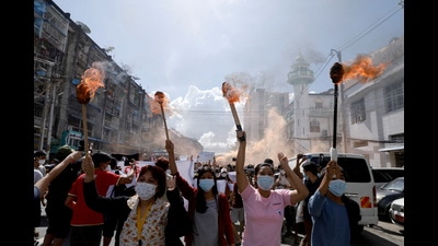 Women hold torches as they protest against the military coup in Yangon, MyanmarM, 2021. (REUTERS) Women hold torches as they protest against the military coup in Yangon, MyanmarM, 2021. (REUTERS)