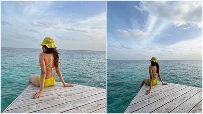 Malavika's second look features a flirty yellow bikini set with a floral print yellow bucket hat. The star sat on a wooden dock by the sea to click photos in this gorgeous ensemble. It features a halter neck bikini top with criss-cross straps on the back and high-rise bikini bottoms. She left her locks open, and for accessories, wore gold bracelets. (Instagram/@malavikamohanan_) Malavika's second look features a flirty yellow bikini set with a floral print yellow bucket hat. The star sat on a wooden dock by the sea to click photos in this gorgeous ensemble. It features a halter neck bikini top with criss-cross straps on the back and high-rise bikini bottoms. She left her locks open, and for accessories, wore gold bracelets. (Instagram/@malavikamohanan_)