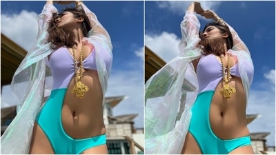 On Monday, Malavika took to Instagram to share photos of herself donning a dual-toned monokini with a shimmery coverup. She captioned the post, "Chanel-ing my inner sea spirit." Additionally, the star made our hearts skip a beat with her windswept tresses and suntanned skin. (Instagram/@malavikamohanan_) On Monday, Malavika took to Instagram to share photos of herself donning a dual-toned monokini with a shimmery coverup. She captioned the post, "Chanel-ing my inner sea spirit." Additionally, the star made our hearts skip a beat with her windswept tresses and suntanned skin. (Instagram/@malavikamohanan_)