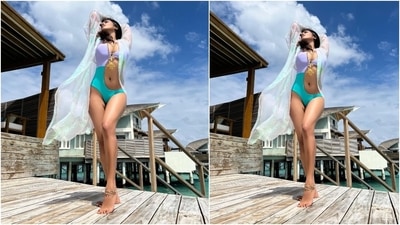 Malavika wore a purple and sea blue-toned swimsuit featuring a cut-out detail on the side, plunging neckline, and a keyhole neckline. She flaunted her enviable frame in the monokini that hugged her body perfectly. An ornate gold chain by Chanel, bracelets and rings rounded it all off. (Instagram/@malavikamohanan_) Malavika wore a purple and sea blue-toned swimsuit featuring a cut-out detail on the side, plunging neckline, and a keyhole neckline. She flaunted her enviable frame in the monokini that hugged her body perfectly. An ornate gold chain by Chanel, bracelets and rings rounded it all off. (Instagram/@malavikamohanan_)