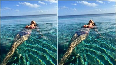 In this photo, the star chilled in an infinity pool wearing a red floral printed swimsuit featuring a bikini top with a sweetheart neckline and high-waisted bikini bottoms. (Instagram/@malavikamohanan_) In this photo, the star chilled in an infinity pool wearing a red floral printed swimsuit featuring a bikini top with a sweetheart neckline and high-waisted bikini bottoms. (Instagram/@malavikamohanan_)